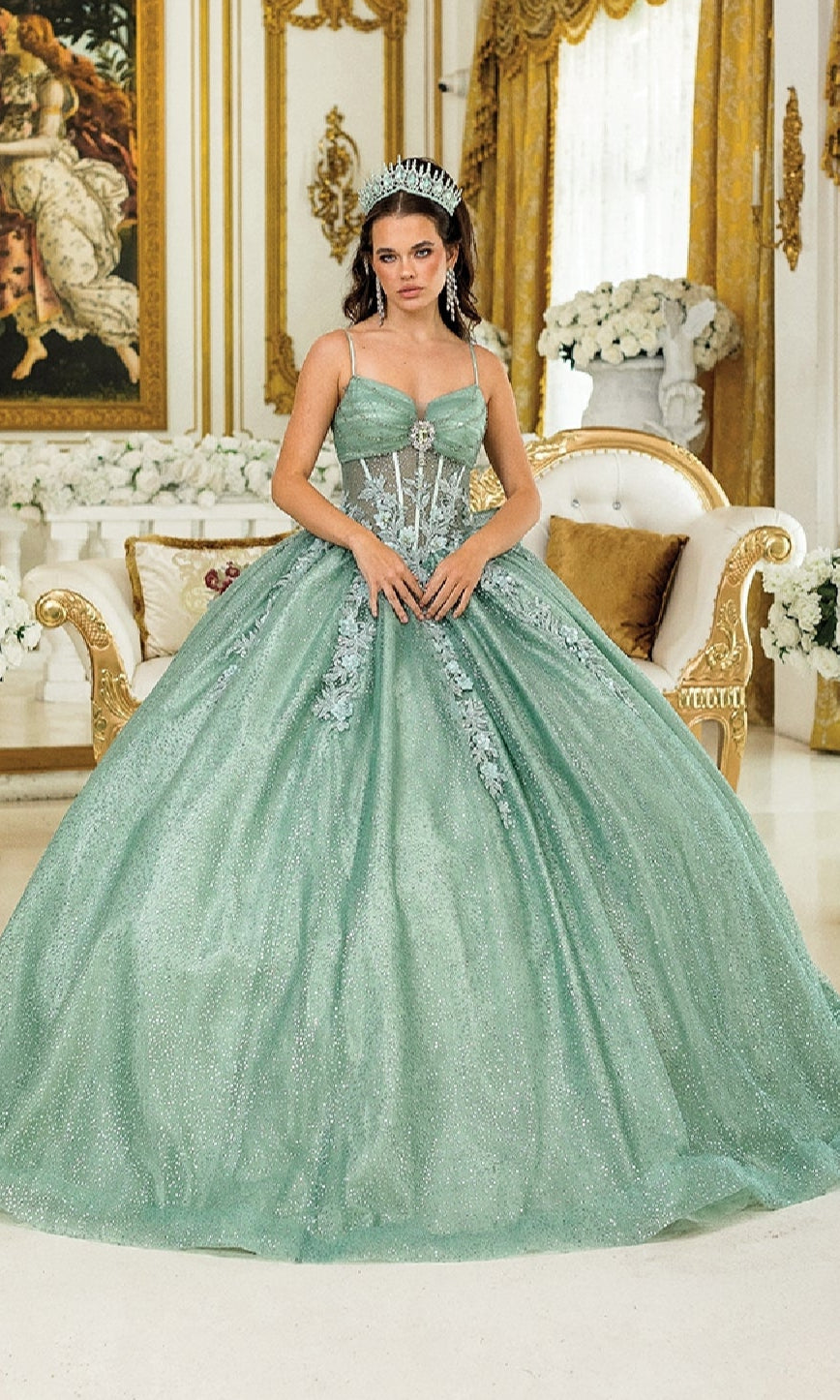 A woman in the Long Quinceañera Dress with Bow: Dancing Queen 1958 stands in an ornate gold-accented room adorned with floral arrangements, her sparkling mint green gown and crown making her shine.